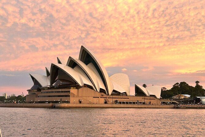 Twilight Treasures Sunset Sydney Harbour Cruise - Passing beneath Sydney Harbour Bridge: the first big golden-hour moment